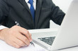 © sorapop - Businessman Sitting Working on Laptop and write note