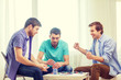 © Syda Productions - happy three male friends playing poker at home