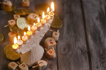 Jewish holiday hannukah symbols - menorah and wooden dreidels. C