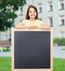 Poster - happy little girl with blank blackboard