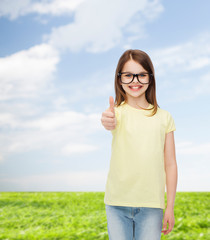 Wall Mural - smiling cute little girl in black eyeglasses