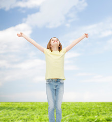 Wall Mural - smiling teenage girl with raised hands