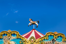 antique carousel horses tent in amusement park