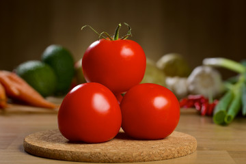 Red tomatoes on the wooden table