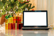laptop with gift box and christmas lights background