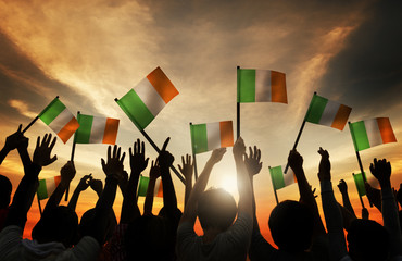 Wall Mural - Silhouettes of People Waving the Flag of Ireland