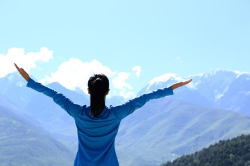 Sticker - cheering young woman hiker open arms mountain peak