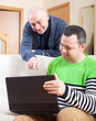 © DariaTrofimova - men  at work on laptop at home.