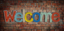 Welcome Word And Brick Wall In Background