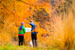 © blas - Couple hiking with map in autumn forest