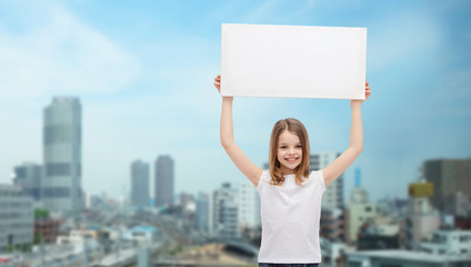 Canvas Print - smiling little girl holding blank white board