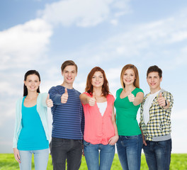 Wall Mural - group of smiling students showing thumbs up