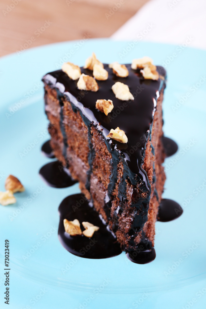 Delicious chocolate cake on plate on table close-up