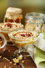 Canvas Print - Tasty dessert with oat flakes and honey, on table