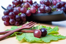 Bunch Of Ripe Red Grapes On A Wooden Tray On Wooden Table