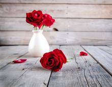 Red Rose In Vase On Wooden Table