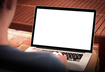 Man using notebook with blank screen while sitting on sofa.