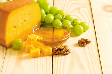 Wall Mural - Smoked cheese, honey, walnuts and grapes