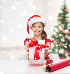 Sticker - smiling girl in santa helper hat with gift box