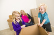© Andy Dean - Young Family In Empty Room Playing With Moving Boxes