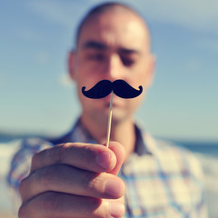 young man with a fake moustache