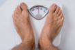 Man Standing On Weight Scale