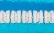 © mrcmos - The white marked lanes is floating in swimming pool.