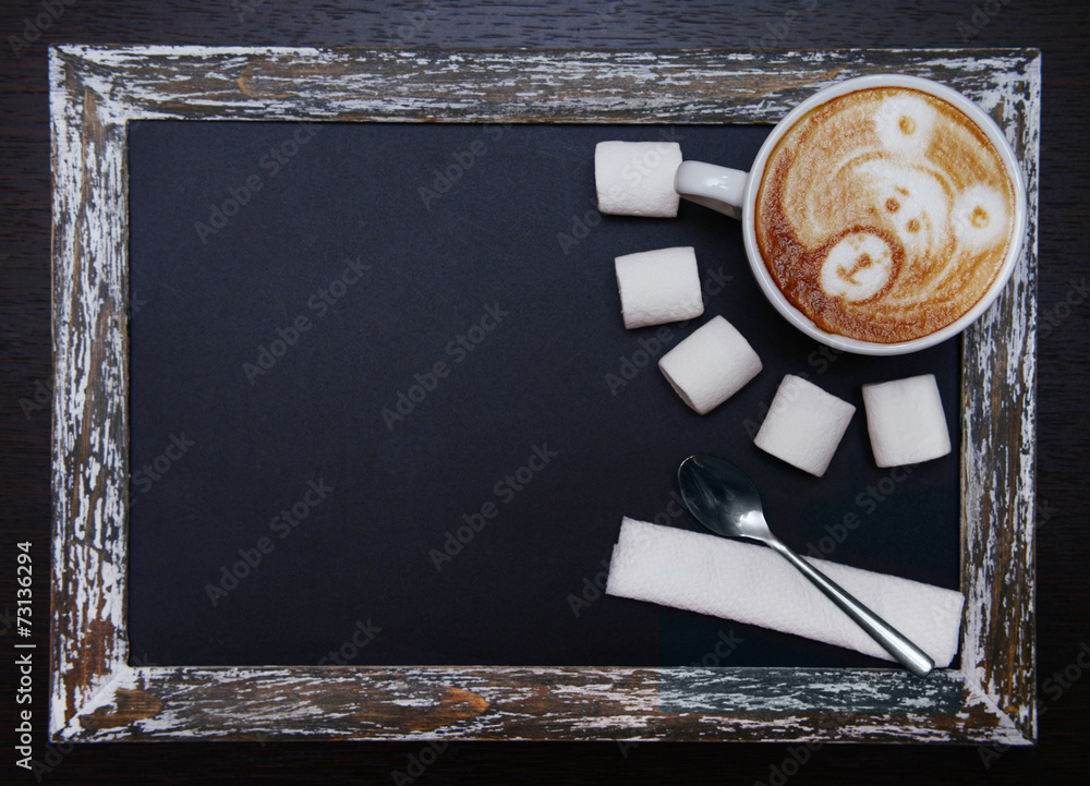 Cup of coffee with cute drawing in cafe