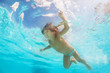 © Sergey Novikov - Small cute boy moving while swimming underwater