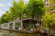 City view of Amsterdam canal and houseboat, Holland, Netherlands