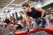 © Syda Productions - group of men with dumbbells in gym