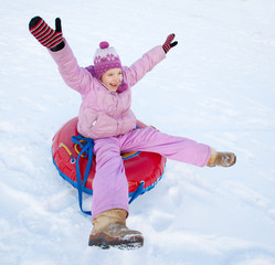 Wall Mural - Child sledding in winter hill