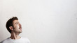 © SFIO CRACHO - Surprised young man looking up