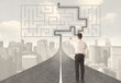 © ra2 studio - Businessman looking at road with maze and solution