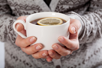 Hands holding a cup of tea