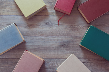 Wall Mural - Old books on wooden background. View from above