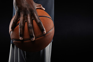 Wall Mural - Hand of basketball player holding a ball