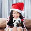 © Mckyartstudio - smiling girl in santa helper hat with teddy bear