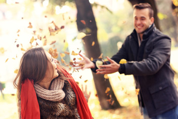 Wall Mural - Happy couple having fun in the park in autumn