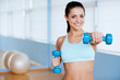 © gstockstudio - Exercising with dumbbells.
