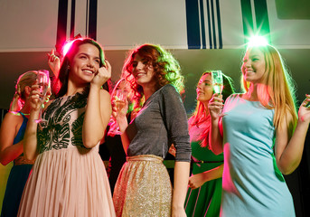 Poster - smiling friends with glasses of champagne in club