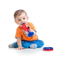 kid playing  with musical toy isolated