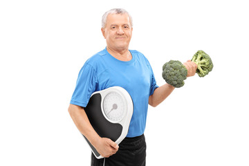 Poster - Senior holding broccoli dumbbell and weight scale