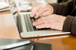 © photopitu - Senior working with Laptop, focus on hands