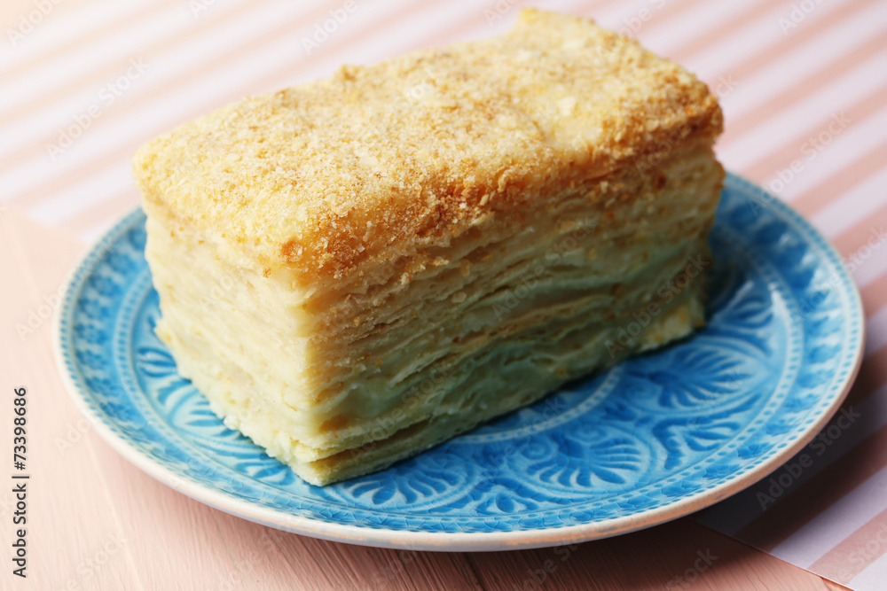 Napoleon cake on plate on table close-up