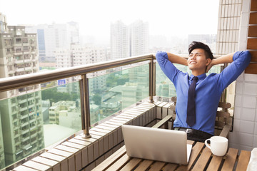 relaxed young business man watching the city view