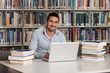© Jale Ibrak - Happy Male Student With Laptop In Library