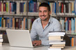 © Jale Ibrak - Happy Male Student With Laptop In Library