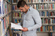 © Jale Ibrak - Happy Male Student With Book In Library