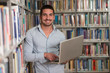 © Jale Ibrak - Happy Male Student With Laptop In Library